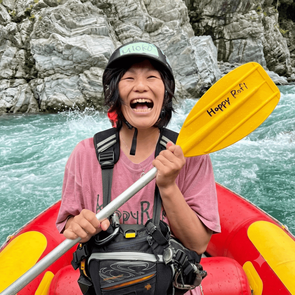 Mioko (Ogachan), river guide at Happy Raft rafting company, laughing on the Yoshino River in the Oboke gorge, Japan.