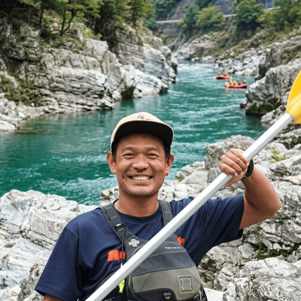 Ramesh, river guide from Nepal at Happy Raft rafting company, on the rocks above the Yoshino River in the Oboke gorge, Japan.