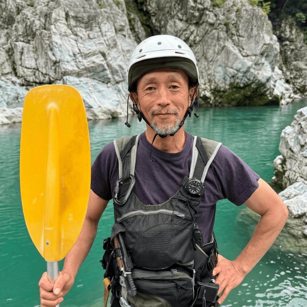 Teru, owner and senior river guide at Happy Raft rafting company, on the Yoshino River in the Oboke gorge, Japan.